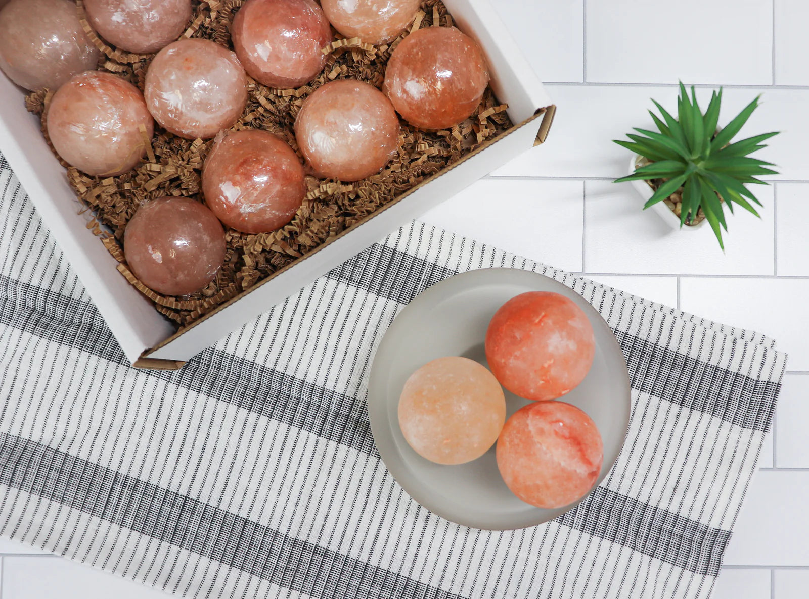 Box of Himalayan pink salt rocks on a checkered tablecloth 