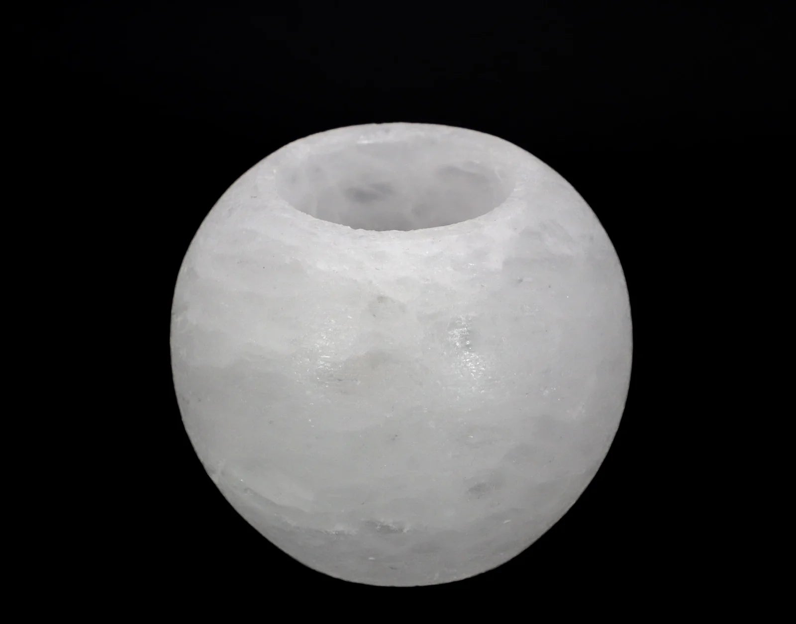 White salt sphere on a black background