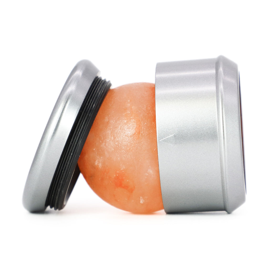 Himalayan salt roller with a metallic base on a white background