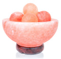 Himalayan salt lamp with pink salt crystals on a white background