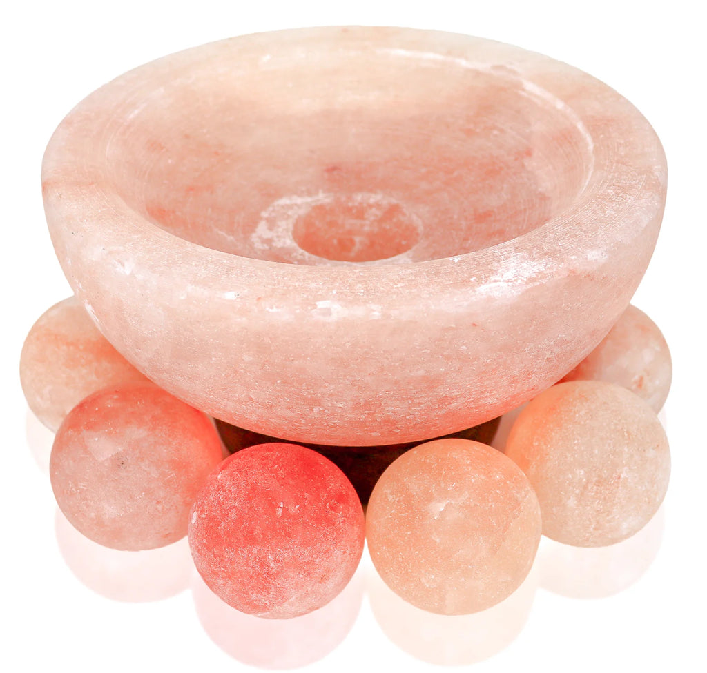 Pink crystal bowl with spherical crystals on a white background