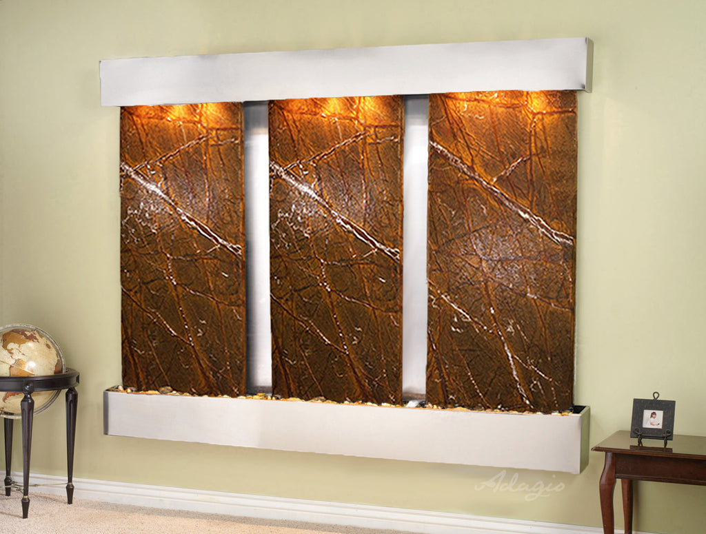 Decorative wall fountain with marble design on a green wall.