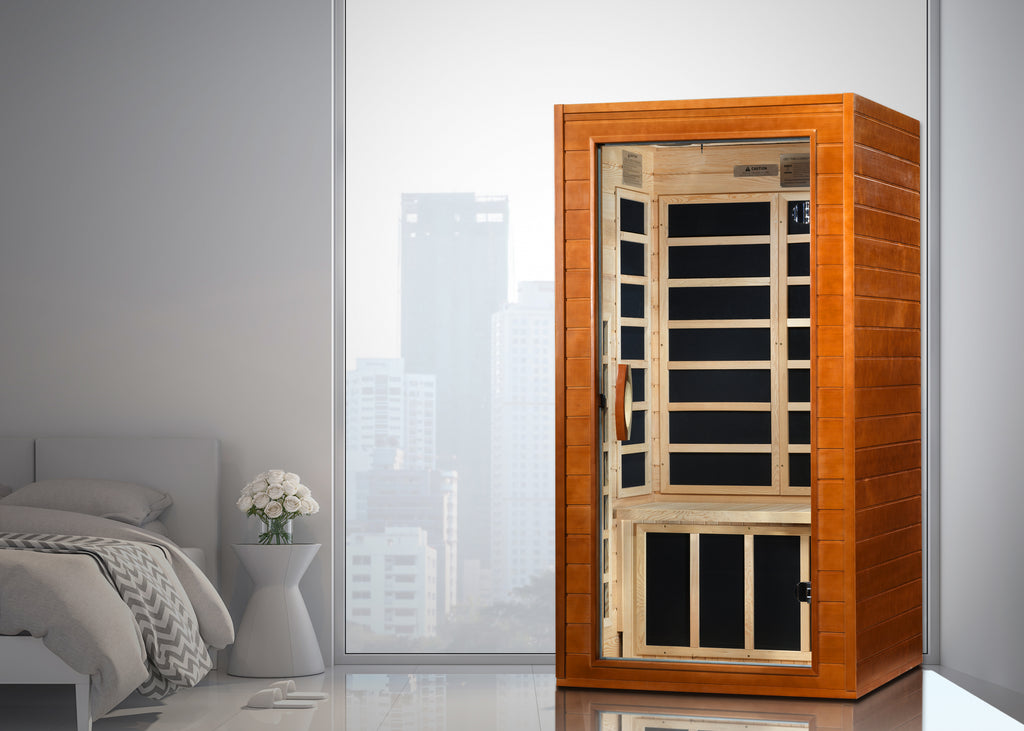 Wooden sauna in a modern room with a bed and window