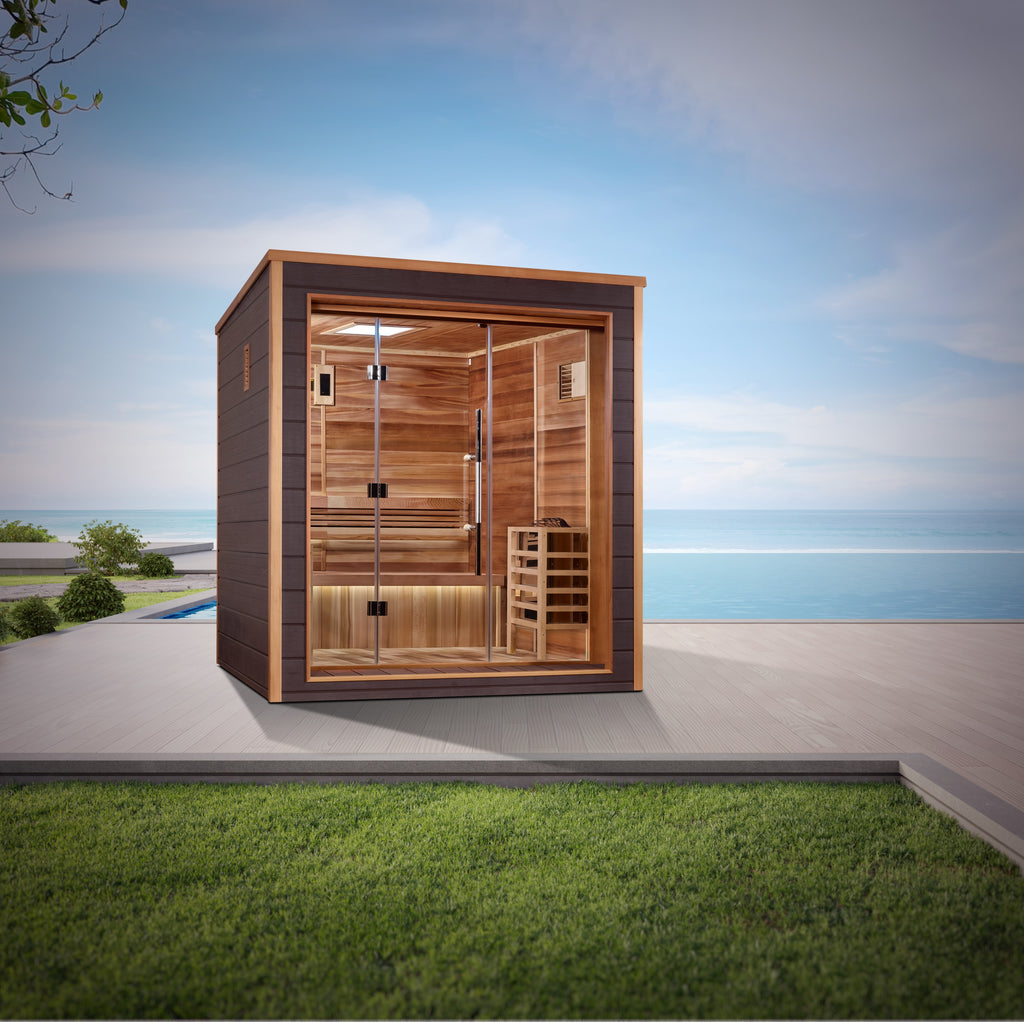 Wooden outdoor sauna with glass door on a patio with grass and blue sky background