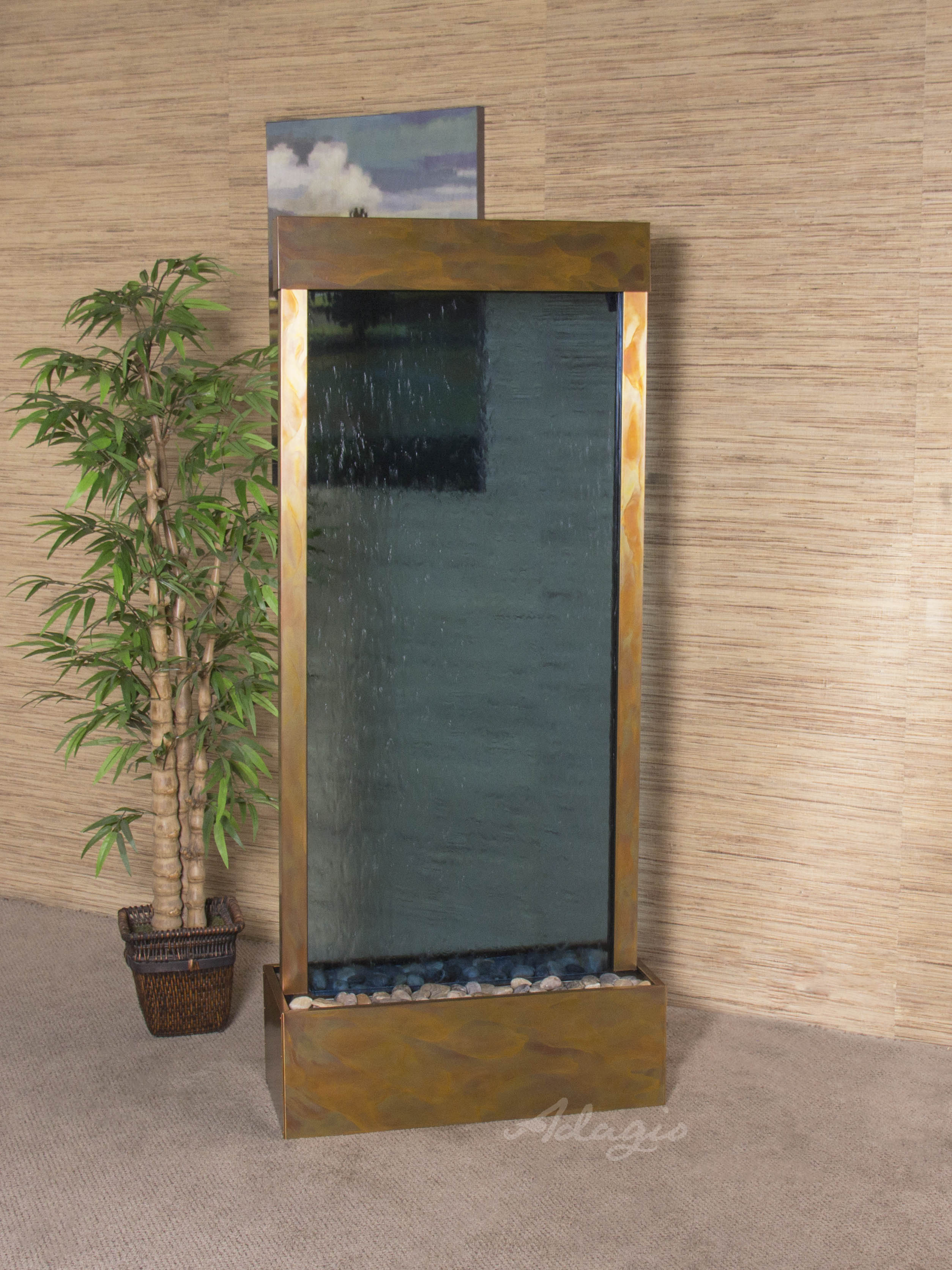 Fountain with mirror and plant against a wooden paneled wall