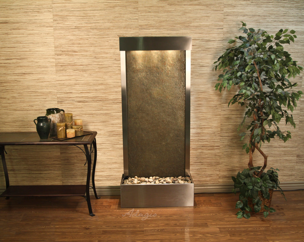 Modern indoor water fountain with decorative elements in a room setting.