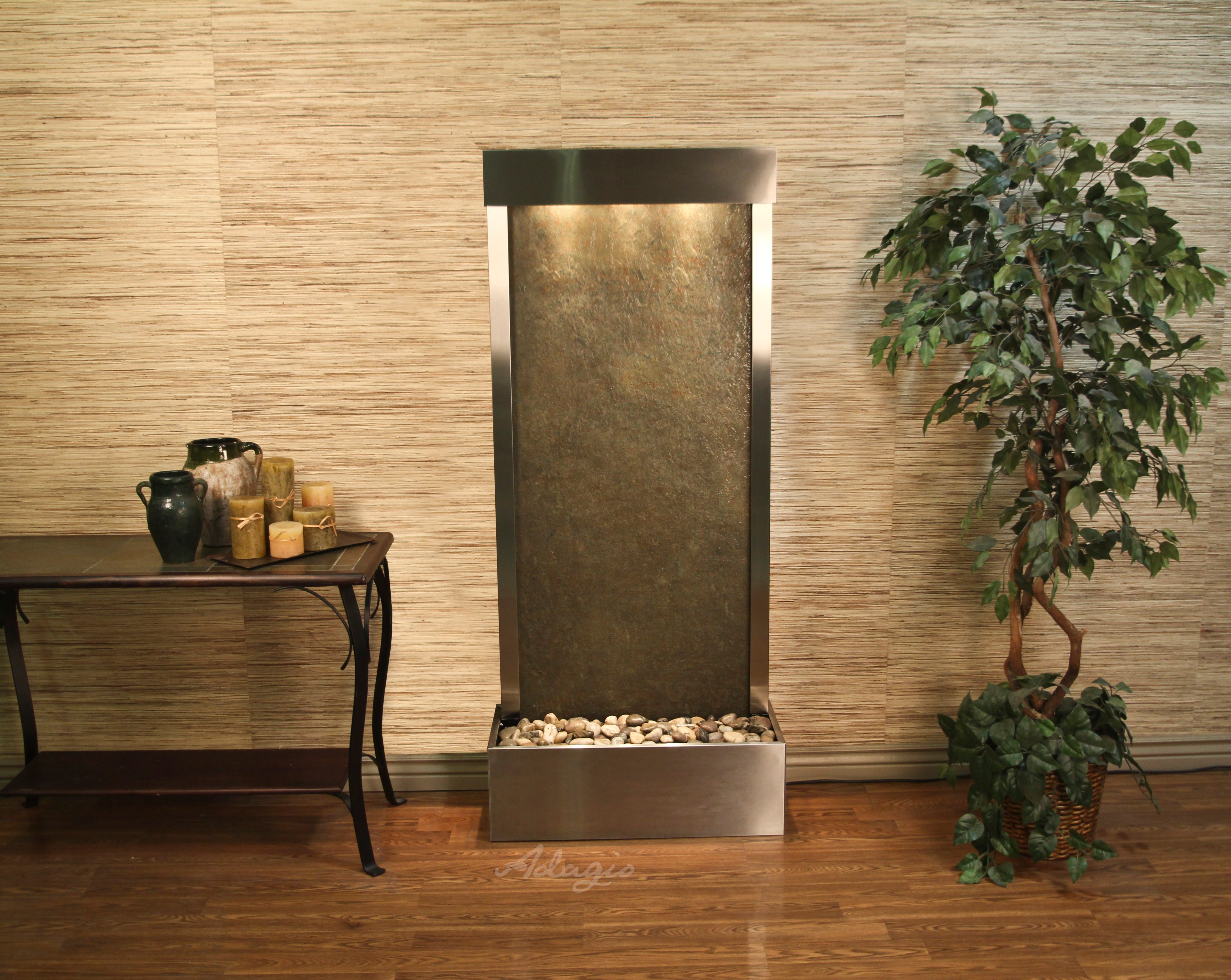 Modern indoor water fountain with decorative elements in a room setting.