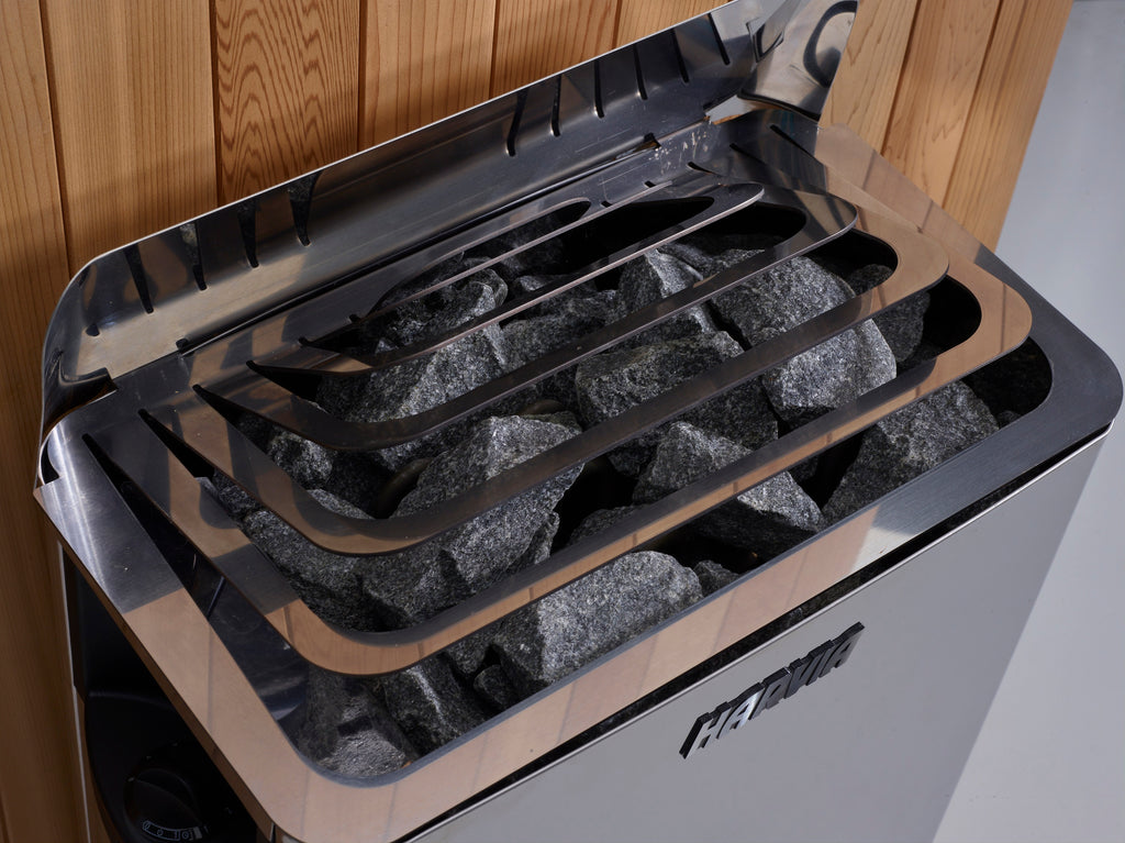 Wall stove with rocks inside,  against a wooden wall.
