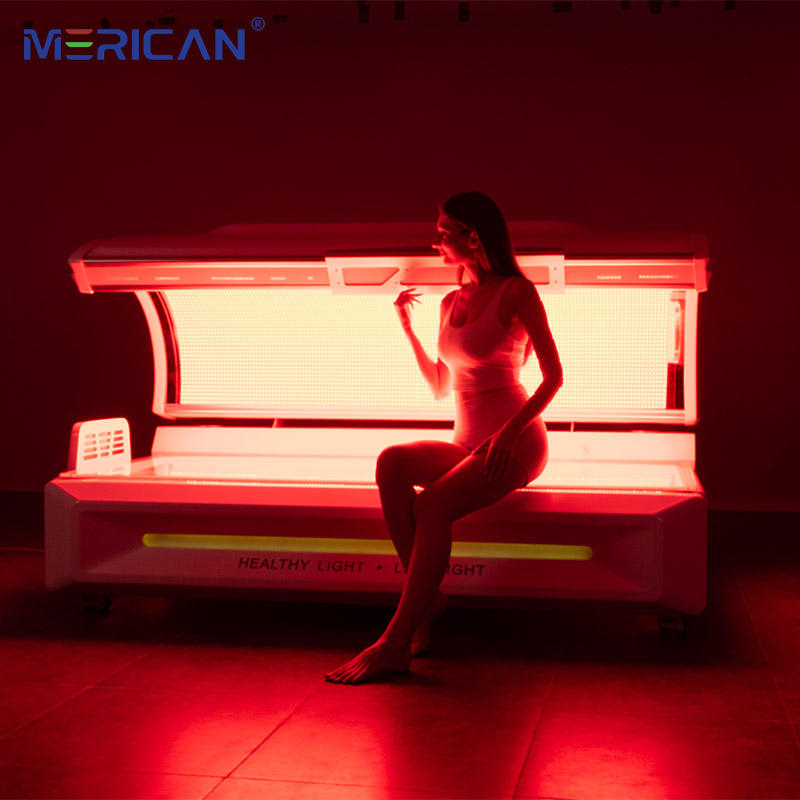 Person sitting on Merican Red light therapy bed in red-lit room