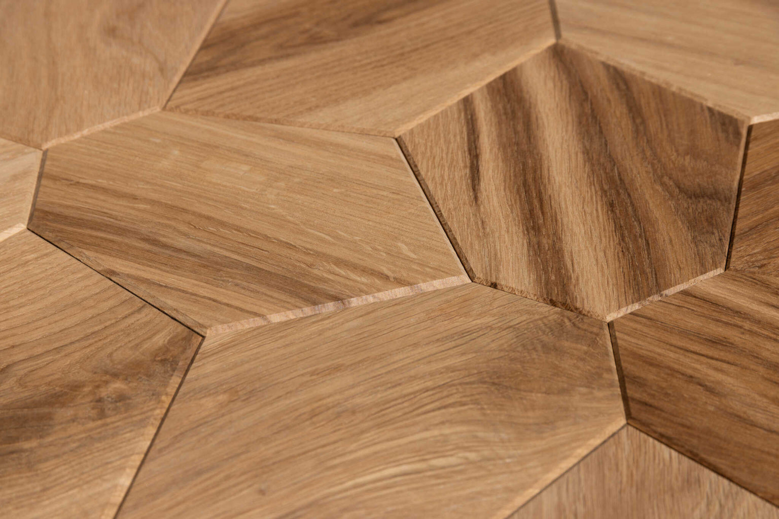 Close-up of hexagonal wooden tiles arranged in a herringbone pattern