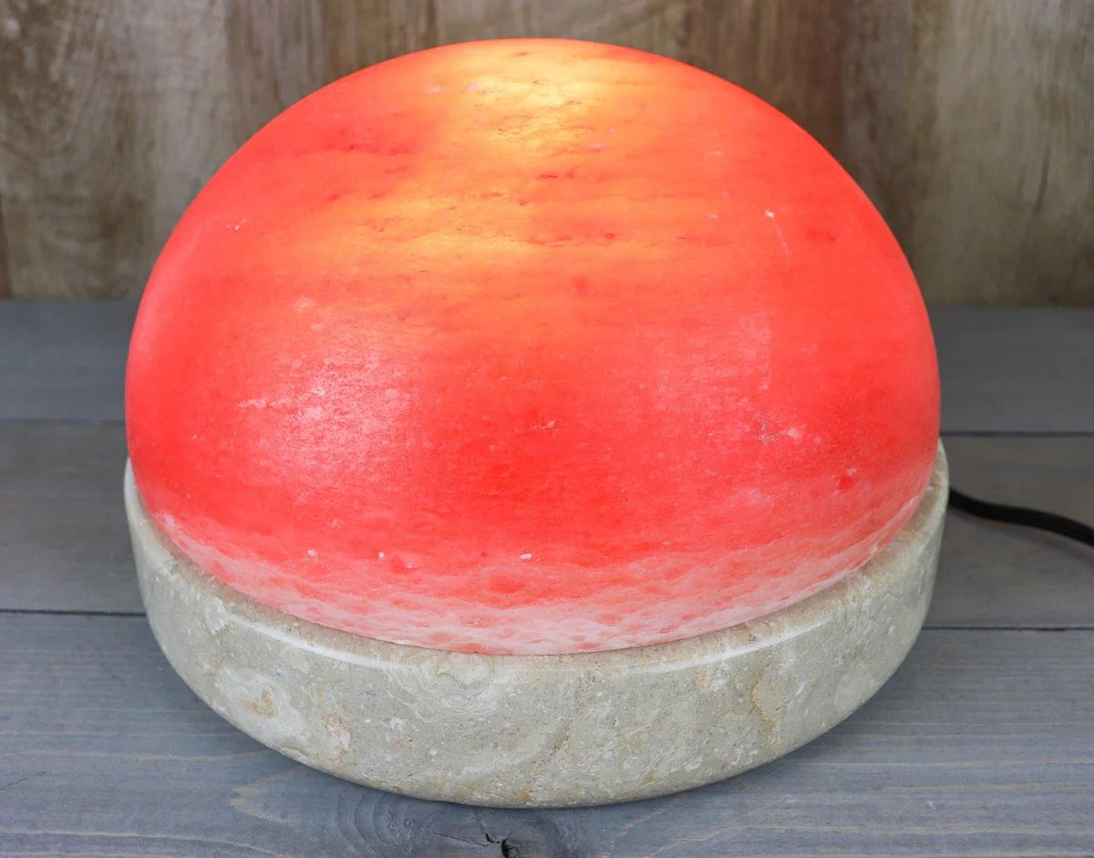 Round salt stone and beige bottom on a wooden surface