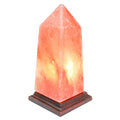 Himalayan salt lamp with a wooden base on a white background