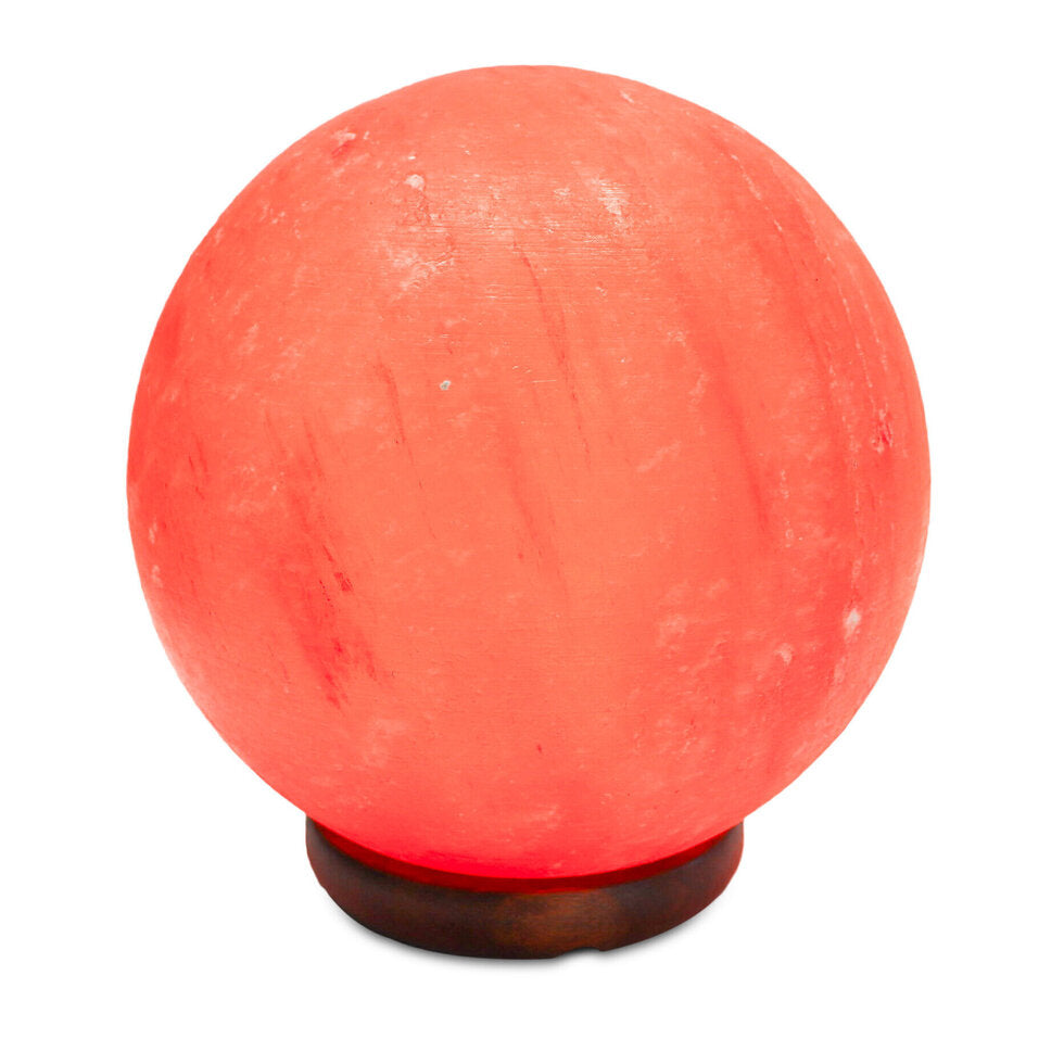 Spherical pink salt lamp with wooden base on a white background