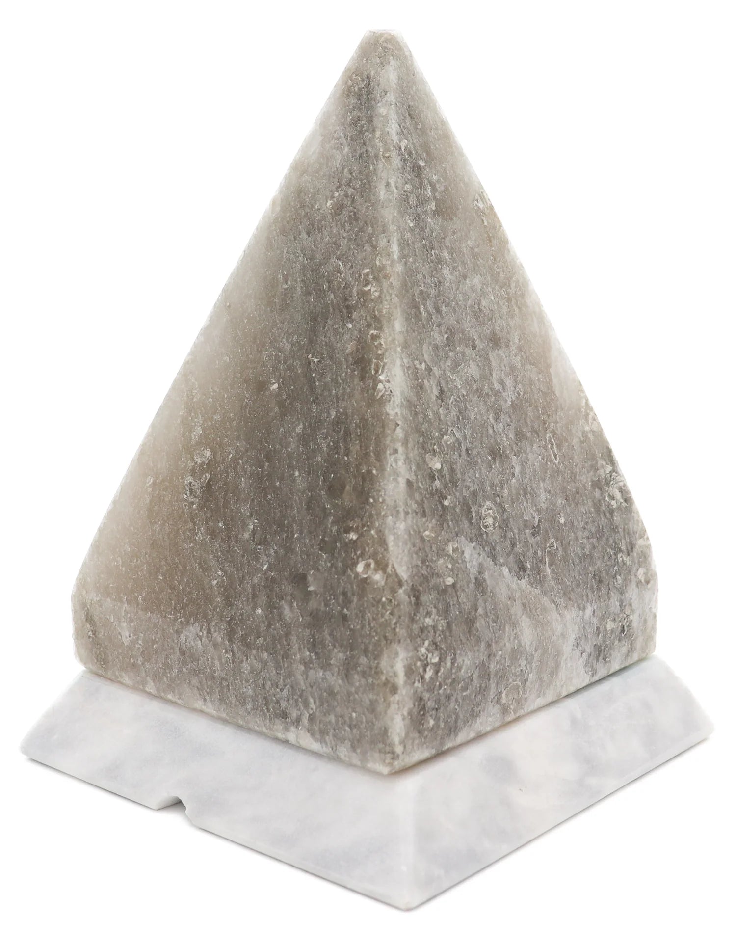 Pyramid-shaped salt lamp on a white base with a white background