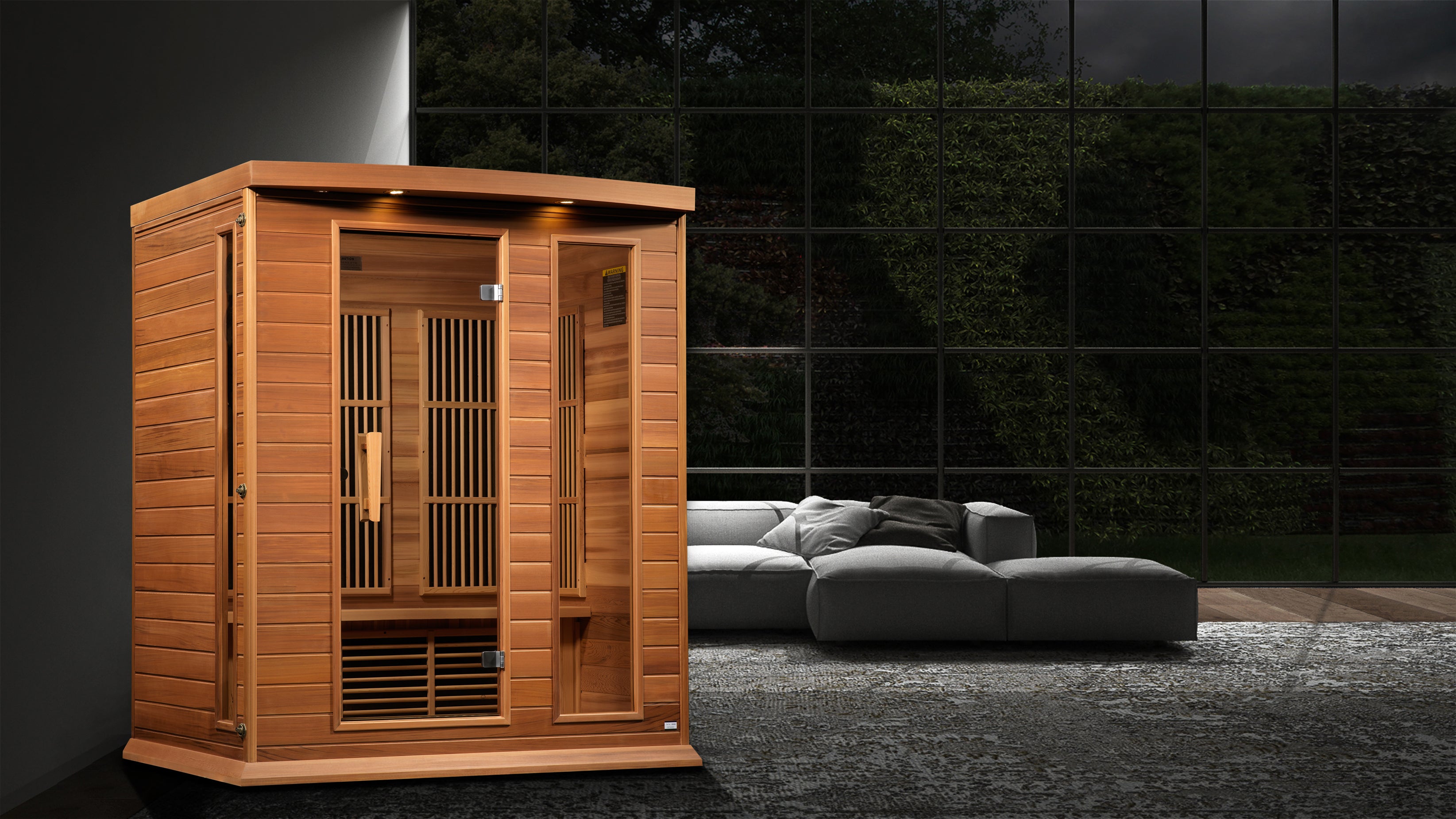 Wooden sauna in an outdoor setting with a modern gray sofa.