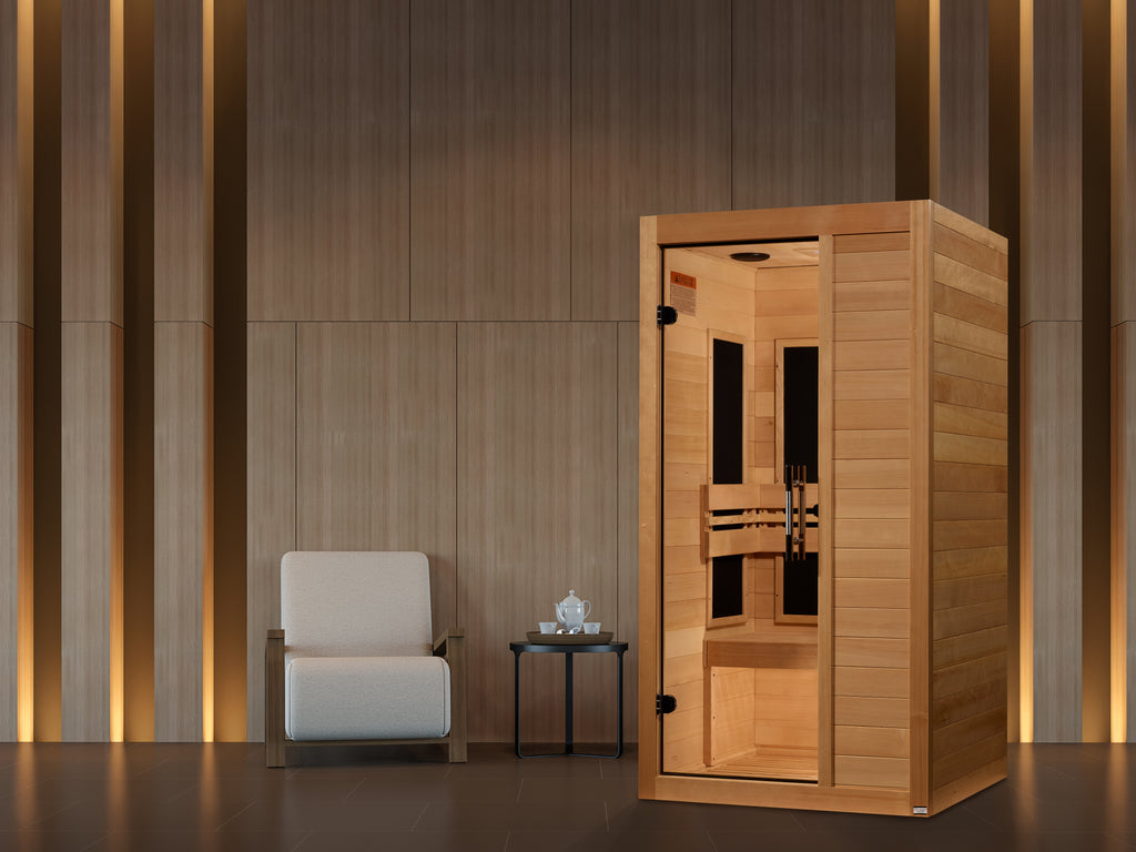 Wooden sauna with a white chair and small table against a wooden wall.