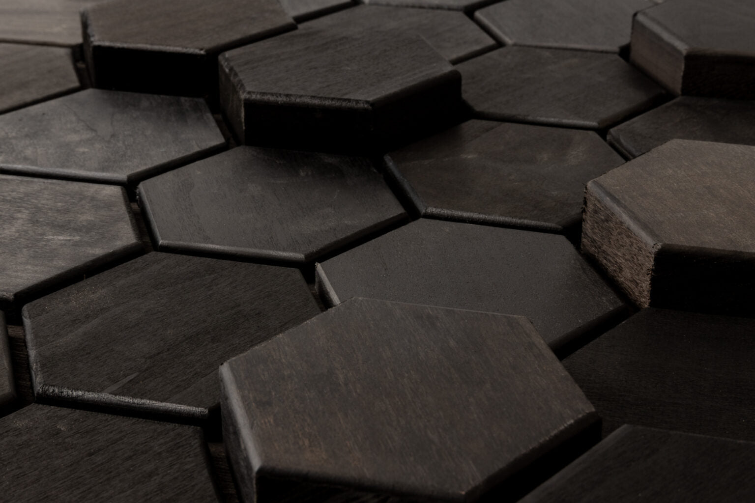 Hexagonal dark wooden tiles arranged in a pattern