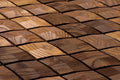 Close-up of a wooden tile pattern with various shades of brown.
