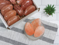 Himalayan salt rocks in a box and on a plate with a plant in the background