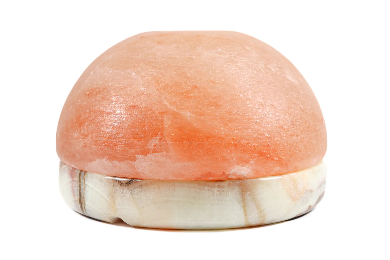 Himalayan salt lamp with a pinkish-orange hue on a white background