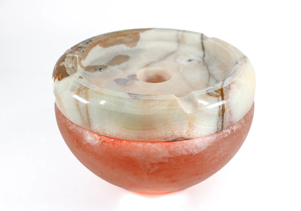 Salt bowl with a natural stone base on a white background
