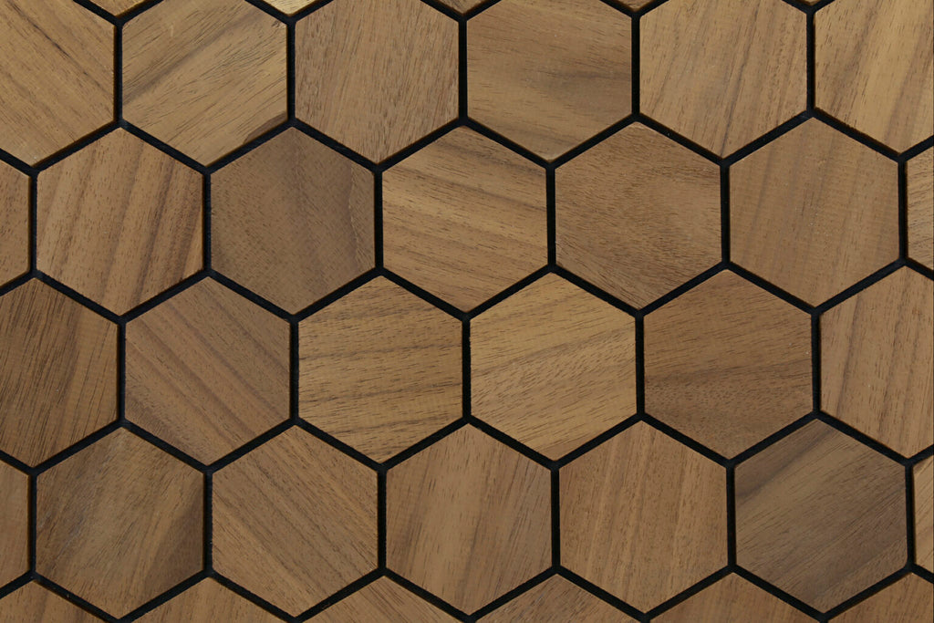Hexagonal wood-patterned tiles with black lines on a wooden surface