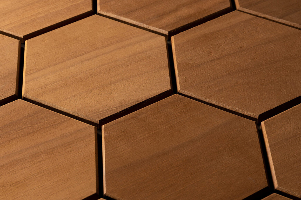 Close-up of hexagonal wooden tiles with a warm brown color.