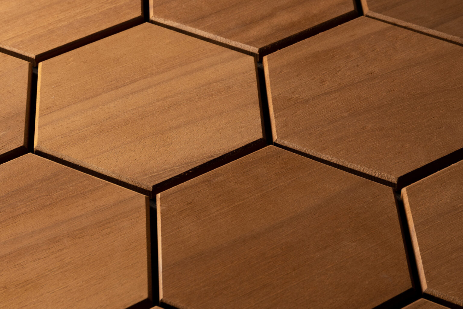 Close-up of hexagonal wooden tiles with a warm brown color.