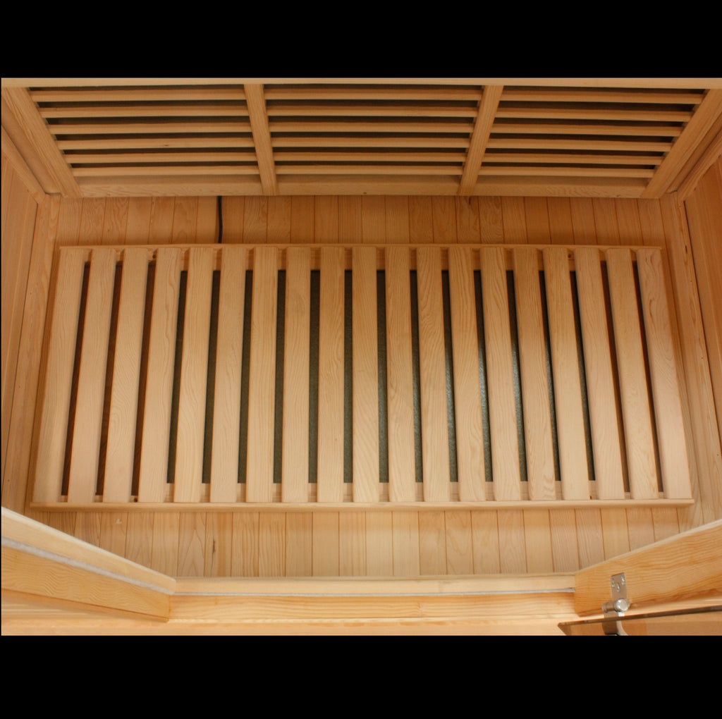Wooden sauna interior with slatted ceiling and bench