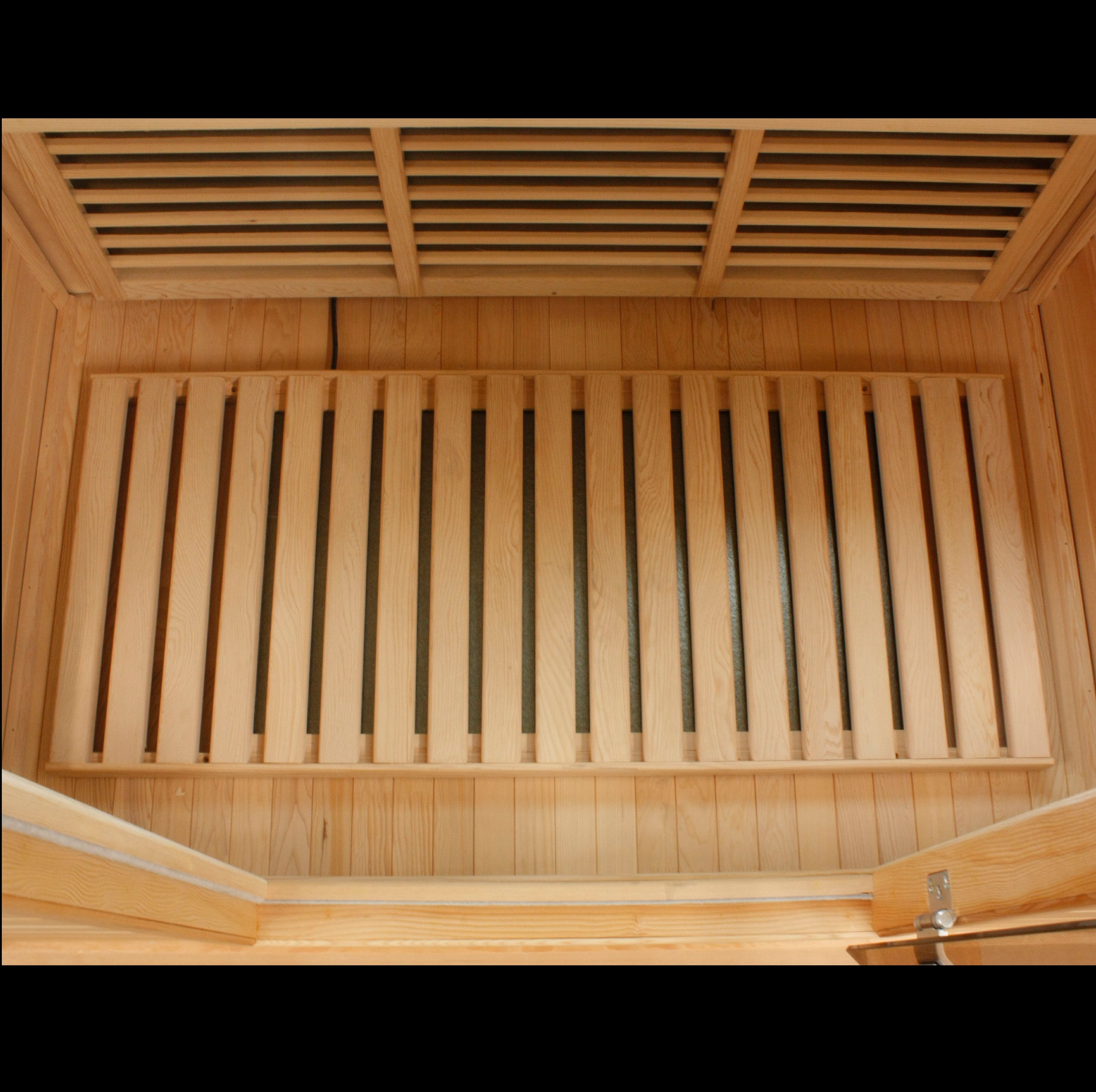 Wooden sauna interior with slatted ceiling and bench