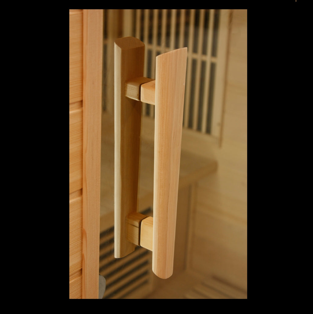 Wooden door handle on a glass door with a blurred interior background