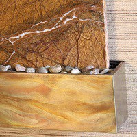 Rustic copper trim with pebbles on a textured wall background