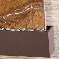 decorative stones in a brown planter box.